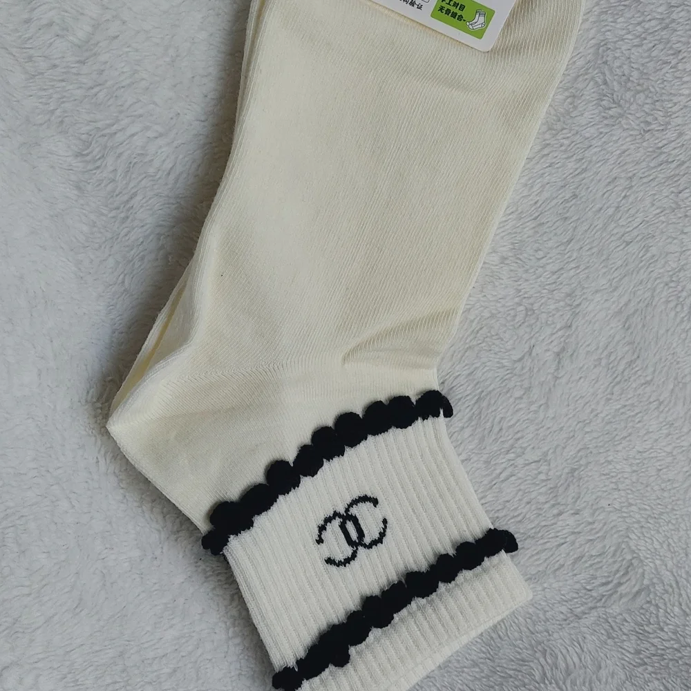 2 Pair of socks. 1 Cream trimmed in Black, 1 Black trimmed In Cream Women Size 7